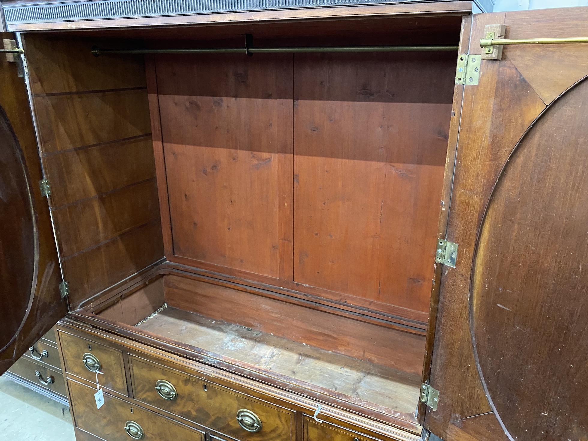 A George III banded mahogany linen press converted to a hanging wardrobe, width 147cm, depth 64cm, height 191cm